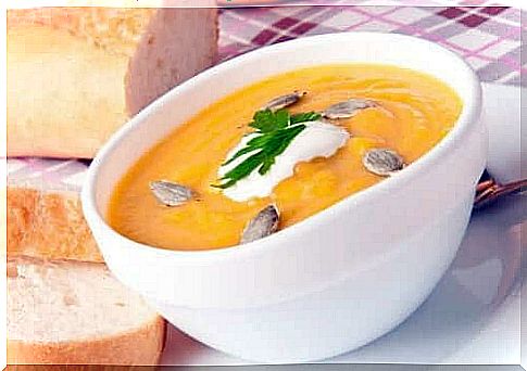 Pumpkin soup with toasted seeds and bread.