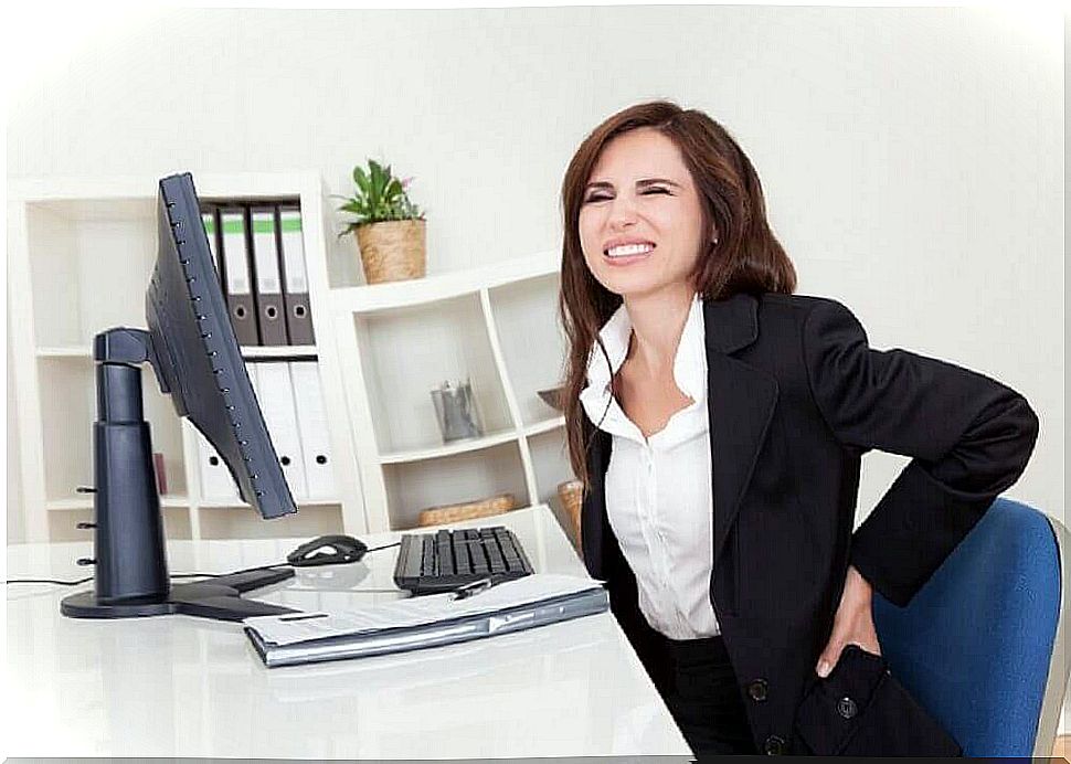 Woman in the office with back pain