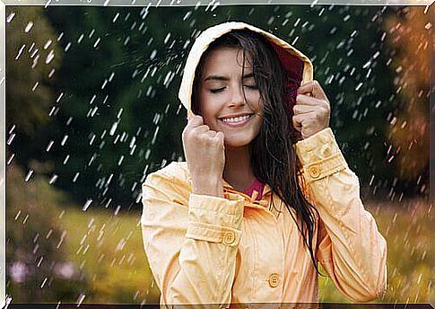 Happy woman in the rain