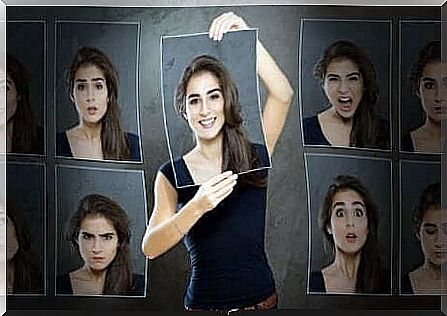 Woman with pictures of many faces, each with different emotions