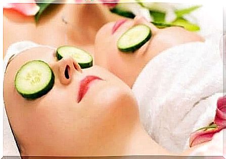 Two women lying with cucumber over their eyes