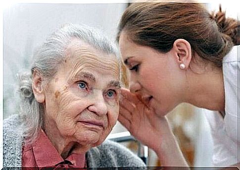 A woman talking to an elderly lady