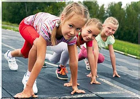 Three young girls get ready for a race.