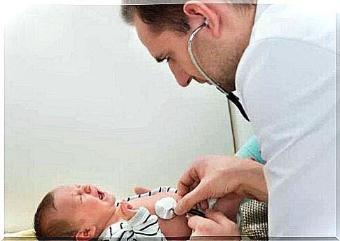 A pediatrician examining a newborn baby.