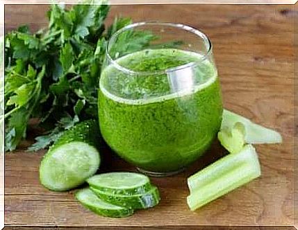 Cucumber juice in a glass on a kitchen counter