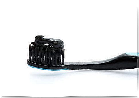 Activated charcoal on a black toothbrush.