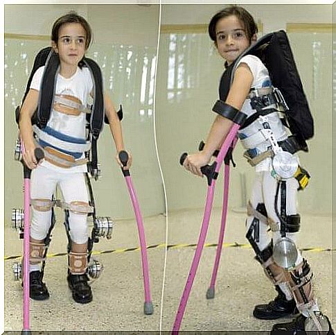 Girl learns to walk with an exhaust skeleton