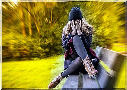 Woman with generalized anxiety disorder sitting on a bench in the park