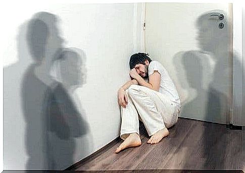 A man sitting disturbed in a corner.